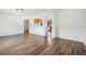 Open-concept living room featuring sleek wood floors and a view into the adjacent kitchen at 3315 W Pearl Ave, Tampa, FL 33611