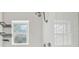Close-up of a shower with white tiled walls, a window, and sleek fixtures at 3315 W Pearl Ave, Tampa, FL 33611