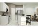 Bright kitchen boasts white cabinets, stainless steel appliances, and a center island with seating at 3469 Lapis Lake Dr, Zephyrhills, FL 33541