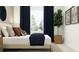 Comfortable main bedroom features a large window, soft lighting, and tasteful decor at 3469 Lapis Lake Dr, Zephyrhills, FL 33541