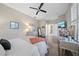 Spacious bedroom with wood-look floors, ceiling fan, and ensuite bathroom at 3543 Gamble St, New Port Richey, FL 34655