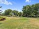 A beautiful neighborhood street offers lush green spaces, sidewalks, and inviting benches to promote an active lifestyle at 3543 Gamble St, New Port Richey, FL 34655