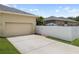 Exterior view of home with a two-car garage and a fenced-in patio area at 3543 Gamble St, New Port Richey, FL 34655