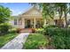 Charming home featuring a cozy front porch, lovely landscaping, and manicured lawn at 3543 Gamble St, New Port Richey, FL 34655