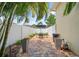 Private patio with a brick-paved floor, white vinyl fence, and seating area with a table and umbrella at 3543 Gamble St, New Port Richey, FL 34655
