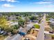Aerial view showing neighborhood streets, houses, and mature trees in a residential area at 3621 Beacon Square Dr, Holiday, FL 34691