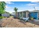 Backyard featuring a sunroom, storage shed and mature landscaping at 3621 Beacon Square Dr, Holiday, FL 34691