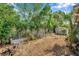 Spacious backyard with gravel and lush green surroundings at 3621 Beacon Square Dr, Holiday, FL 34691