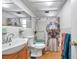 Bathroom featuring a shower/tub combo, toilet and a vanity with sink and mirror at 3621 Beacon Square Dr, Holiday, FL 34691