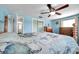 Bedroom features wood floors, blue walls, closet and a wood frame bed at 3621 Beacon Square Dr, Holiday, FL 34691