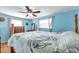 Light and airy bedroom with light blue walls, wood furniture, and overhead fan at 3621 Beacon Square Dr, Holiday, FL 34691