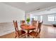 Bright dining space with wood floors, features wood table and view to living room at 3621 Beacon Square Dr, Holiday, FL 34691