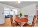 Bright dining area with a wood table, chairs, and view into a living space with a blue couch at 3621 Beacon Square Dr, Holiday, FL 34691
