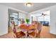 Bright dining room with view of kitchen and second living space featuring wood table and chairs at 3621 Beacon Square Dr, Holiday, FL 34691
