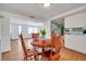 Bright dining room with a wood table and chairs, open to the kitchen and living room spaces at 3621 Beacon Square Dr, Holiday, FL 34691