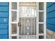 Front door with security features and decorative glass inserts at 3621 Beacon Square Dr, Holiday, FL 34691