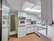 Cozy kitchen featuring white cabinets, a built-in oven, and a stainless steel refrigerator at 3621 Beacon Square Dr, Holiday, FL 34691