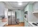 Kitchen with stainless steel refrigerator and a pass-through to an adjacent living space at 3621 Beacon Square Dr, Holiday, FL 34691