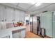 Well-lit kitchen leading to a dining area and featuring stainless steel refrigerator at 3621 Beacon Square Dr, Holiday, FL 34691