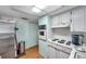 Cozy kitchen equipped with a built-in oven, stainless steel refrigerator, and cooktop at 3621 Beacon Square Dr, Holiday, FL 34691