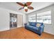 Bright living room with a ceiling fan, wood-look floors, and view of the backyard at 3621 Beacon Square Dr, Holiday, FL 34691