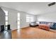 Bright living room featuring wood flooring, a comfortable sofa, and large window for natural light at 3621 Beacon Square Dr, Holiday, FL 34691