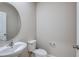 Powder room featuring a modern sink, toilet, mirror and neutral paint at 37114 Sagemoor Dr, Zephyrhills, FL 33541