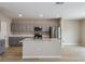 Bright kitchen with gray cabinets, a kitchen island, and stainless steel appliances at 37114 Sagemoor Dr, Zephyrhills, FL 33541