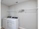Functional laundry room equipped with modern washer and dryer units plus wire shelving for storage at 37114 Sagemoor Dr, Zephyrhills, FL 33541