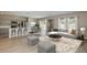 Bright and airy living room with a modern sofa, stylish coffee table, and seamless kitchen access at 37114 Sagemoor Dr, Zephyrhills, FL 33541