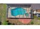 Aerial view showcasing a pool with a screened enclosure, a patio, and a well-maintained yard at 3908 Lithia Ridge Blvd, Valrico, FL 33596