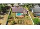 Aerial view of a home with a screened pool, mature landscaping, and backyard garden at 3908 Lithia Ridge Blvd, Valrico, FL 33596