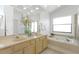 Bright bathroom featuring double sinks, large mirror and soaking tub at 3908 Lithia Ridge Blvd, Valrico, FL 33596