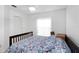 Cozy bedroom features patterned bedding, a ceiling fan and natural light from a window at 3908 Lithia Ridge Blvd, Valrico, FL 33596