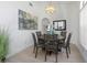 Charming dining area with a wooden table, modern lighting fixture, and neutral decor at 3908 Lithia Ridge Blvd, Valrico, FL 33596