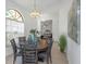 Elegant dining room featuring a round table, stylish chandelier, and views into the living area at 3908 Lithia Ridge Blvd, Valrico, FL 33596