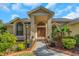 Inviting front entrance with decorative double doors, lovely landscaping, and a brick-lined walkway at 3908 Lithia Ridge Blvd, Valrico, FL 33596