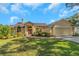 Charming single-story home with a well-manicured lawn and beautifully landscaped garden beds at 3908 Lithia Ridge Blvd, Valrico, FL 33596