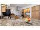 Bright kitchen featuring granite counters, central island, stainless hood, and wood cabinetry at 3908 Lithia Ridge Blvd, Valrico, FL 33596