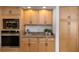 Modern kitchen design with stainless steel appliances, wood cabinets and granite countertops at 3908 Lithia Ridge Blvd, Valrico, FL 33596