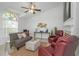 Cozy living room with a vaulted ceiling, comfortable seating, and natural light from the large window at 3908 Lithia Ridge Blvd, Valrico, FL 33596