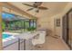 Inviting covered patio with outdoor seating, perfect for dining by the pool at 3908 Lithia Ridge Blvd, Valrico, FL 33596