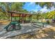 Covered picnic area featuring multiple picnic tables and trash receptacles in a community space at 3908 Lithia Ridge Blvd, Valrico, FL 33596