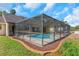 Backyard view of the pool with a screened enclosure, patio, and landscaped perimeter at 3908 Lithia Ridge Blvd, Valrico, FL 33596