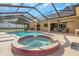 Relaxing screened-in pool and spa with a spacious deck, bar, and comfortable seating area at 3908 Lithia Ridge Blvd, Valrico, FL 33596
