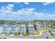 Aerial view of coastal homes featuring garages, landscaping, and community amenities under a partly cloudy sky at 4357 Marina View Way, Cortez, FL 34215