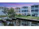 Beautiful backyard featuring multiple homes with balconies, canal access with boat docks, and green landscaping at 4357 Marina View Way, Cortez, FL 34215