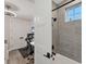 This bathroom is equipped with tiled shower, office desk, and a modern overhead fan at 4357 Marina View Way, Cortez, FL 34215