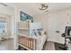 White-themed bedroom with bunk beds, a ceiling fan, and a picturesque wall art at 4357 Marina View Way, Cortez, FL 34215