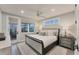 Relaxing main bedroom featuring neutral colors, a ceiling fan, and a private outdoor entrance to a patio at 4357 Marina View Way, Cortez, FL 34215